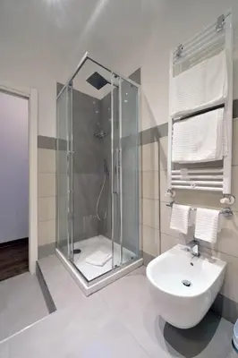 a bathroom with a shower and a toilet and a sink at Star Vatican Rooms in Rome