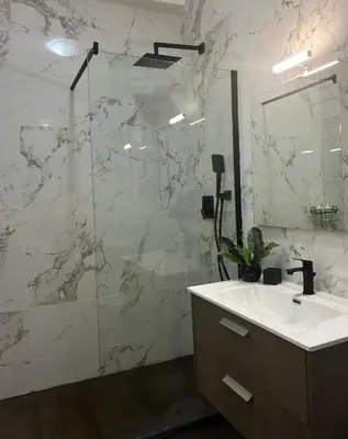 a bathroom with a sink and a glass shower at Candelor House - Apartment & Garden in Gianicolense in Rome