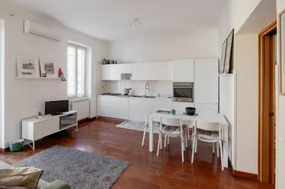 a kitchen with a table and chairs in a room at Domus Alberone in Rome