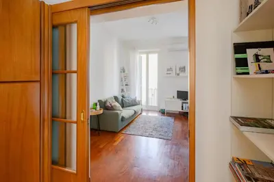 an open door to a living room with a couch at Domus Alberone in Rome