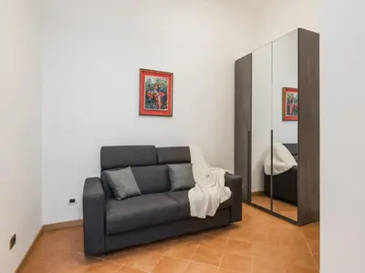 a living room with a couch and a mirror at The Best Rent - Three-bedroom apartment near the Quirinale in Rome