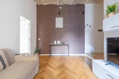 a living room with a couch and a fireplace at Charming Vatican Apartment in Rome