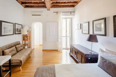 a living room with a bed and a couch at Domus Paolina in Rome