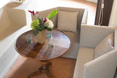 a table with a vase of flowers and two chairs at Amazing Fontana di Trevi in Rome
