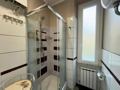 a bathroom with a shower with a glass door at Le Due Civette Roma in Rome