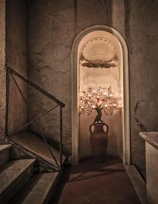 a hallway with a vase with a plant in it at 47LuxurySuites - Trevi in Rome