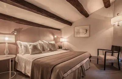 a bedroom with a large bed and a chair at 47LuxurySuites - Trevi in Rome