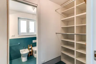 a bathroom with a toilet and a sink at Trastevere 2 bdr orto botanico with private patio in Rome