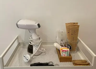 a bathroom with a blow dryer in the corner of a room at The Room 15 in Rome