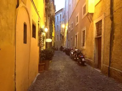 an alley with motorcycles parked on a street at night at Casina Roma, 2 min to Piazza Navona in Rome