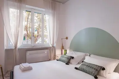 a bedroom with a white bed and a window at laDolceVita - Flaminio Stylish Flat in Rome