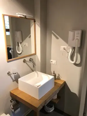 a bathroom with a white sink and a mirror at All'antico molino in Rome