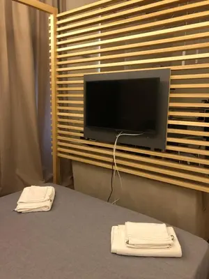 a room with a table with a television and two white towels at All'antico molino in Rome
