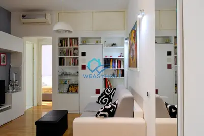 a living room with a couch and a book shelf at Your Roman Retreat near San Giovanni in Rome