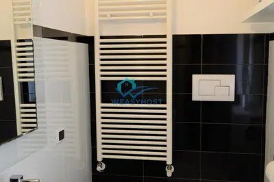 a bathroom with a towel rack on the wall at Your Roman Retreat near San Giovanni in Rome