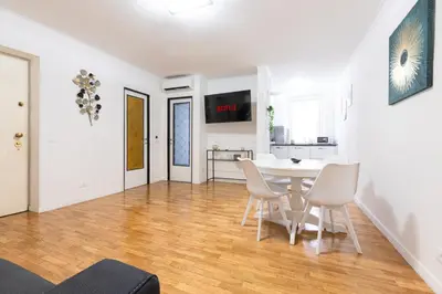 a kitchen and dining room with a table and chairs at Mosaic Trastevere Silver Apartment in Rome