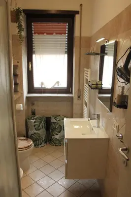 a bathroom with a sink and a toilet and a window at Capital House Roma in Rome