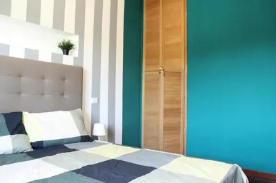 a bedroom with a bed and a blue wall at Capital House Roma in Rome