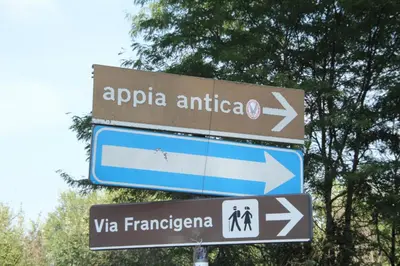 a street sign with arrows pointing in different directions at Capital House Roma in Rome