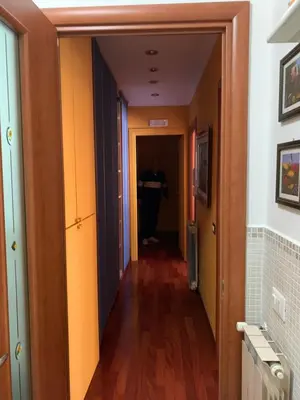 a hallway with a person standing at a desk in a room at LunaBed Roma - Affitti brevi in Rome