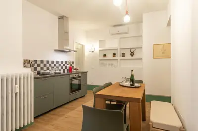 a kitchen and dining room with a table and chairs at Popolo Charming Apartment in Rome