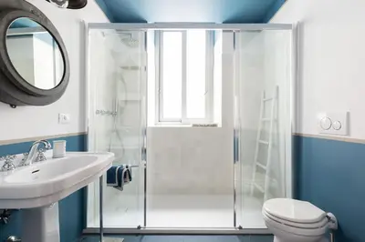 a bathroom with a shower and a toilet and a sink at Popolo Charming Apartment in Rome