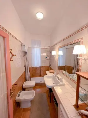 a bathroom with two sinks and a toilet and a tub at Living in Vatican City in Rome