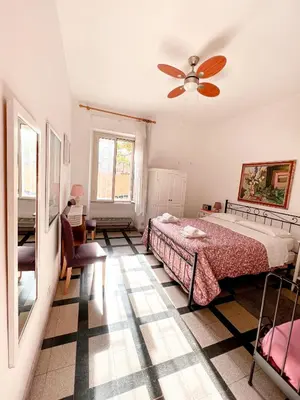 a bedroom with a bed and a ceiling fan at Living in Vatican City in Rome
