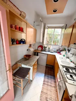 a small kitchen with a table and a sink at Living in Vatican City in Rome