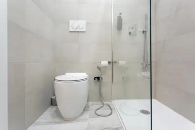 a bathroom with a toilet and a glass shower at APT Rome 5 BDRMs in Rome