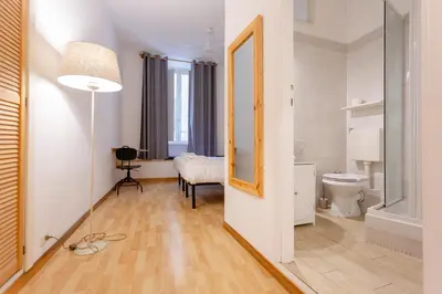 a hallway with a bathroom with a toilet and a mirror at APT Rome 5 BDRMs in Rome