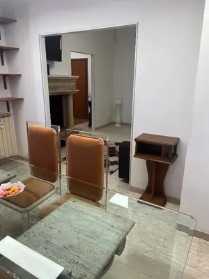 a room with chairs and a mirror and a piano at Nic Roma House in Rome