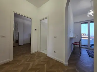 a room with a hallway with a door and a chair at Trastevere Dreamer Home Rome in Rome