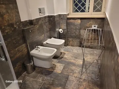 a bathroom with a toilet and a sink at Vatican house 98 in Rome