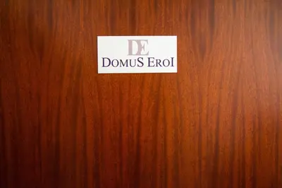 a wooden door with a sign on it at Domus Eroi in Rome