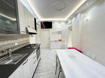 a kitchen with a sink and a table in it at IMPERIUM INN in Rome