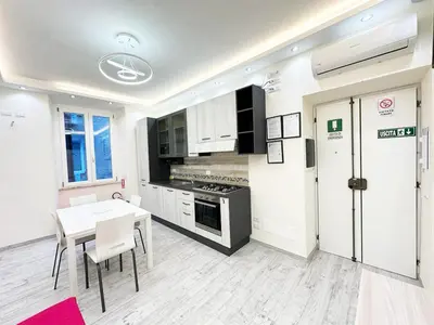 a kitchen with a table and a stove top oven at IMPERIUM INN in Rome