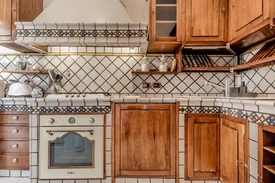 a kitchen with wooden cabinets and an oven at Luxury Giorgi Home in Rome