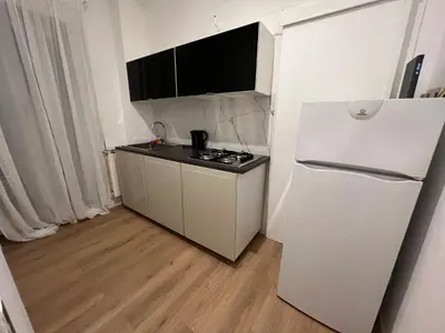 a small kitchen with a white refrigerator in a room at Luxury Suite Rialto in Rome