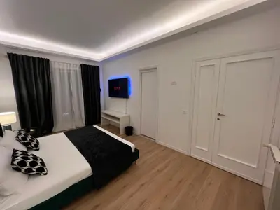 a bedroom with a bed and a tv in it at Luxury Suite Rialto in Rome