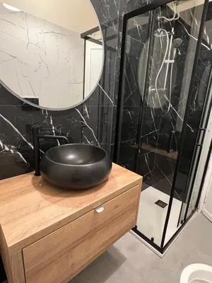 a black bathroom with a black sink and a mirror at Luxury Suite Rialto in Rome