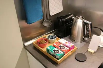 a kitchen counter with a tray of food and a kettle at Policlinico Apartment in Rome