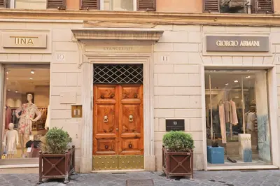 a store front with a wooden door and two windows at Romerooms Condotti in Rome