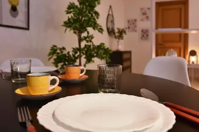 a table with a plate and two cups on it at Suite a pochi passi da S. Pietro in Rome