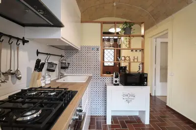 a kitchen with a stove and a sink at [Termini Treasure] - Elegant retreat in Rome
