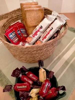 a basket filled with snacks and bread on a table at The green place alloggio turistico in Rome