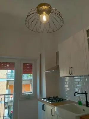 a kitchen with a light hanging from the ceiling at The green place alloggio turistico in Rome