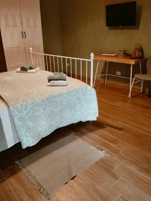 a bedroom with a bed and a wooden floor at The green place alloggio turistico in Rome