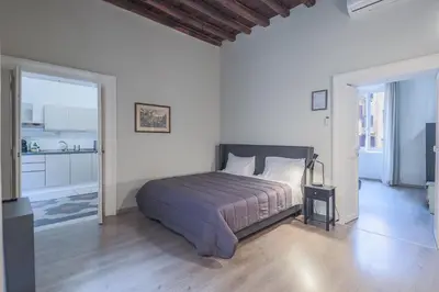 a bedroom with a bed in a white room at Prefetti 46 in Rome