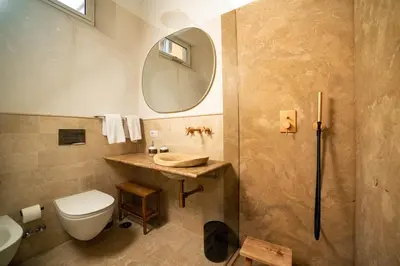 a bathroom with a toilet and a sink and a mirror at Casa Monti Club in Rome